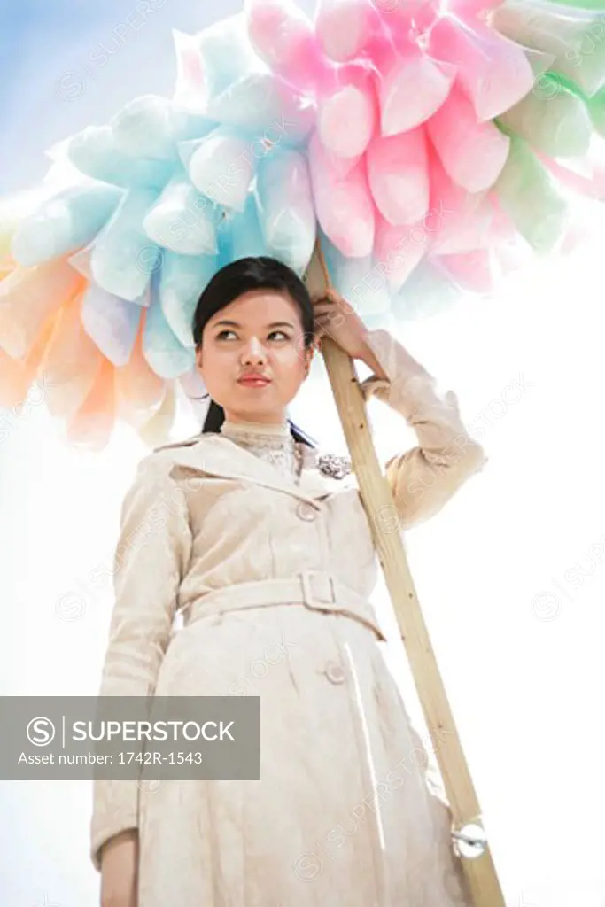 Asian woman holding cotton candy