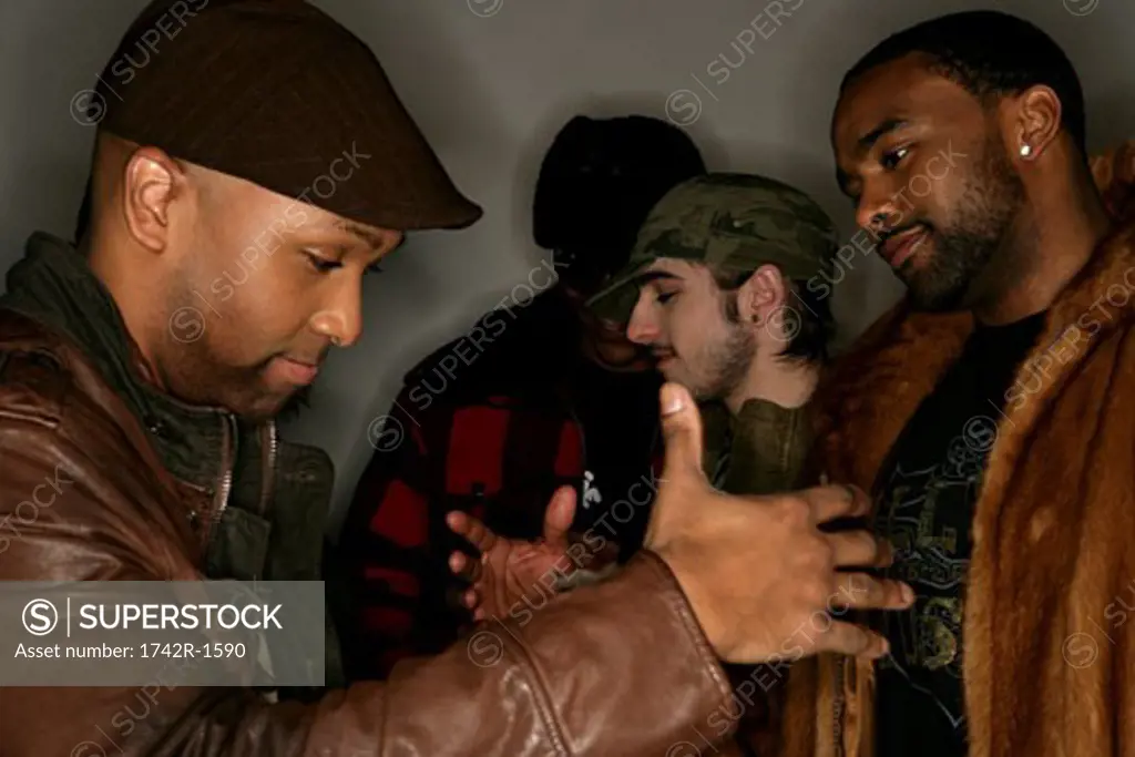 Four young men greeting each other