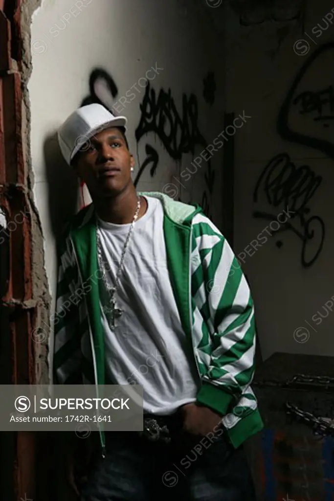 Young man leaning against the wall