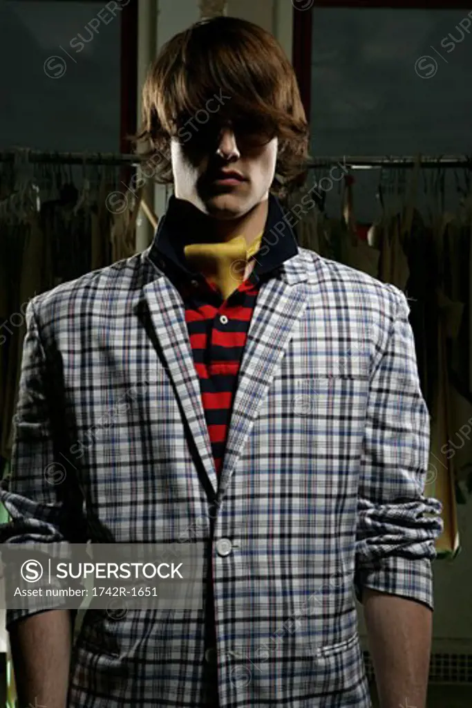 Young man wearing shades and a plaid jacket