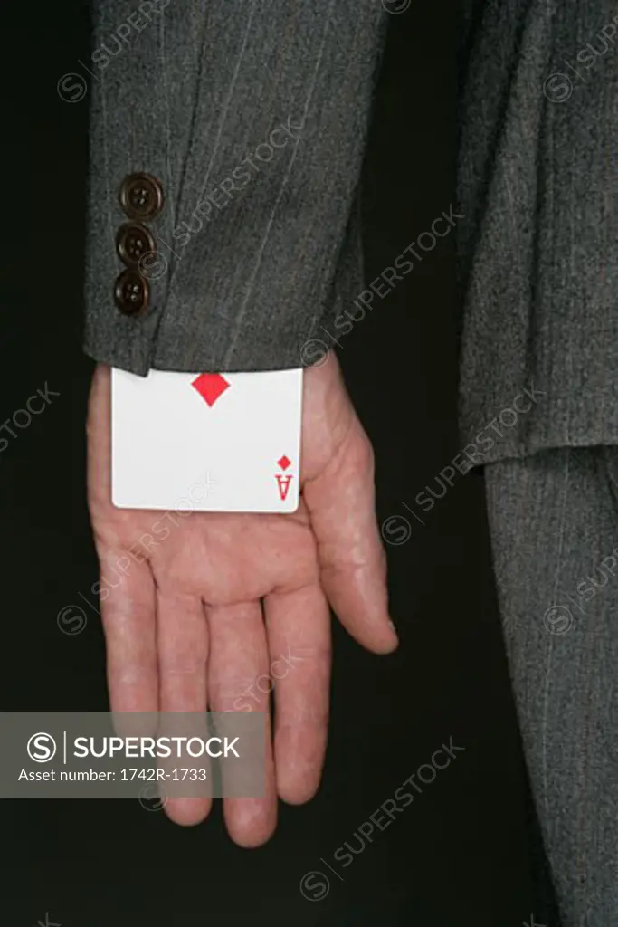 Businessman with playing card under his sleeve