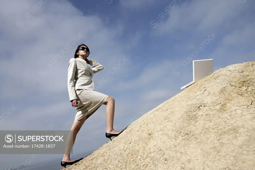 View of a woman standing on a cliff.