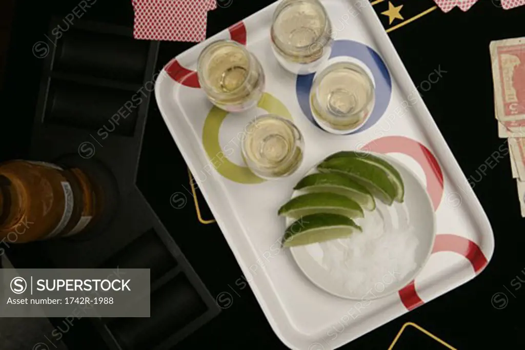 View of wineglasses and lemons served on a tray.