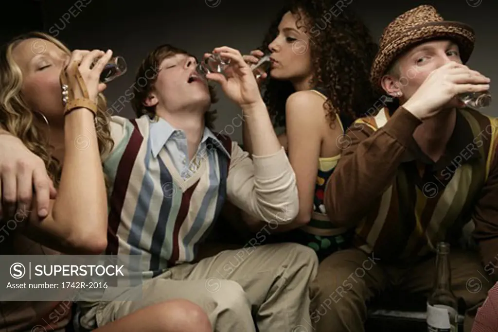 Four young people drinking