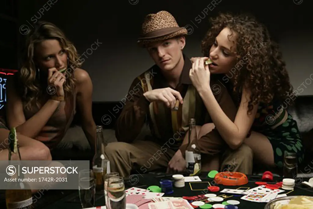Three people playing cards