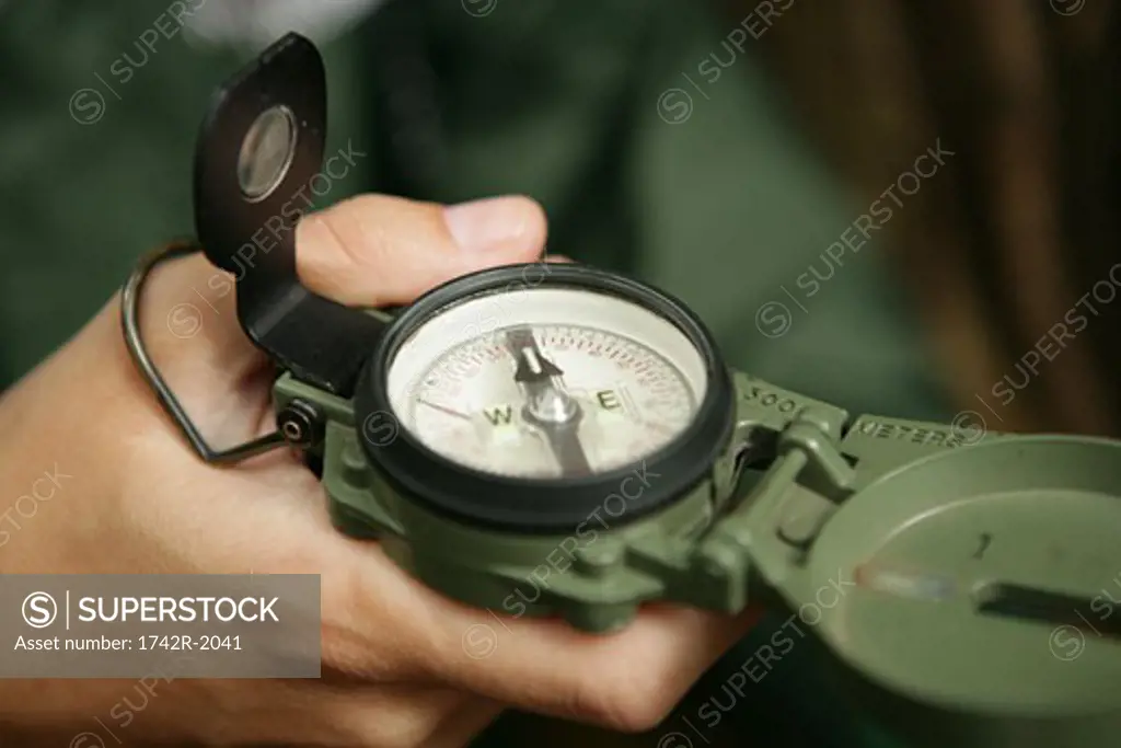 View of a person holding a compass.