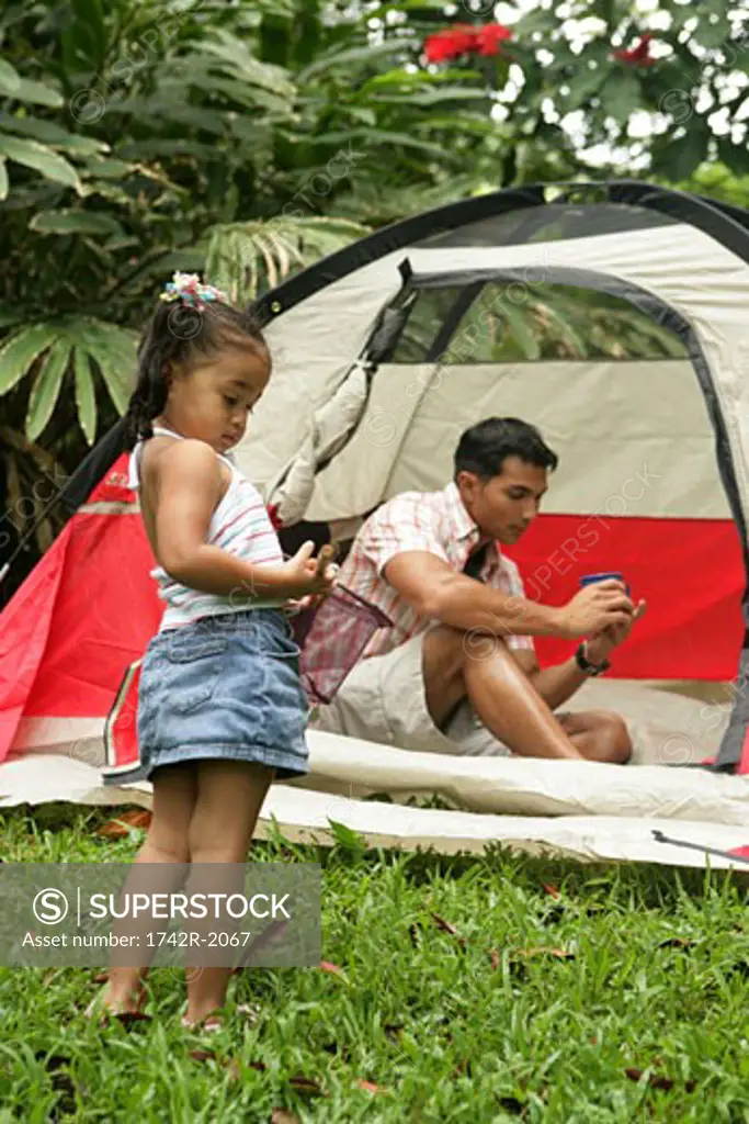Small Girl standing in front of tent