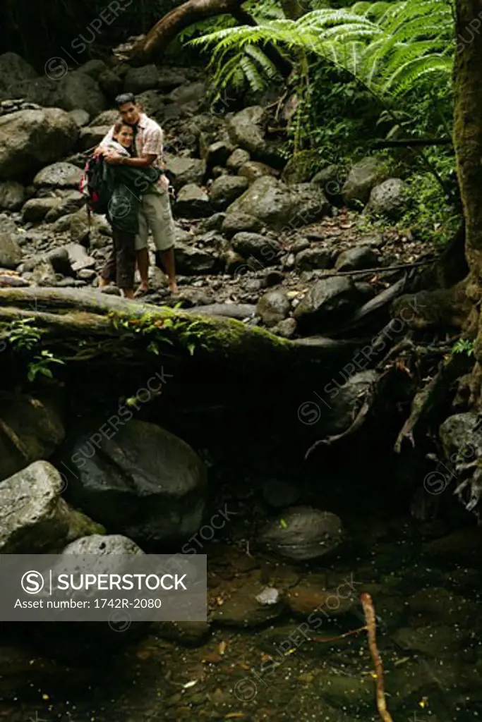Couple hugging inside forest
