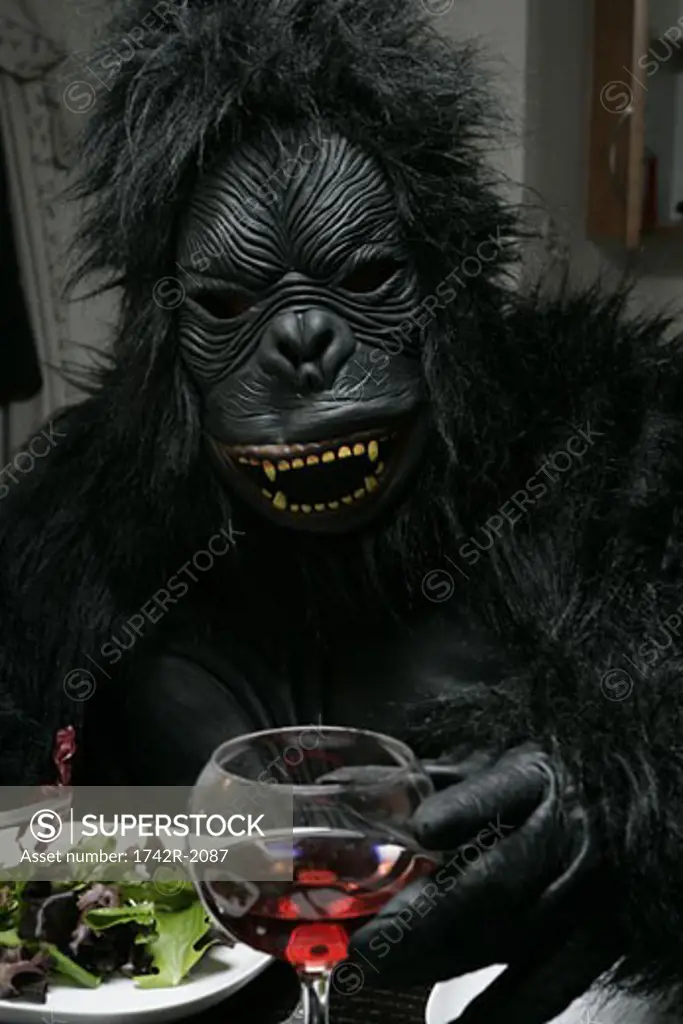 Person dressed up as gorilla eating.