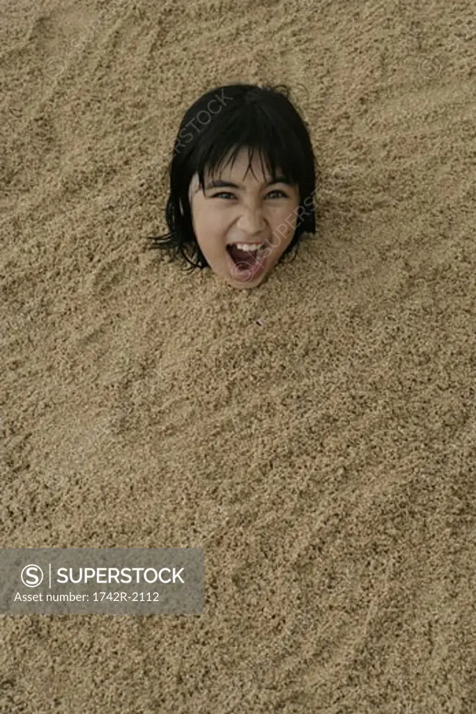View of a girl buried in sand.