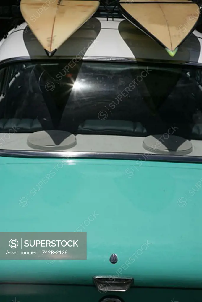 View of two surfboards on top of a car.
