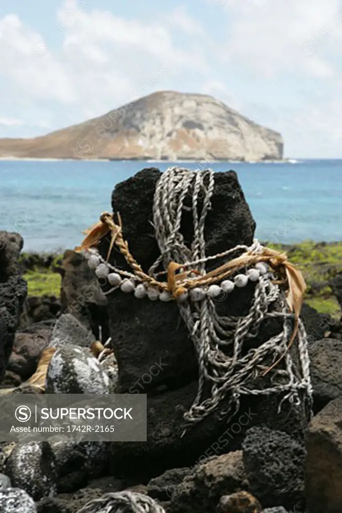 View of ropes bound around a rock.