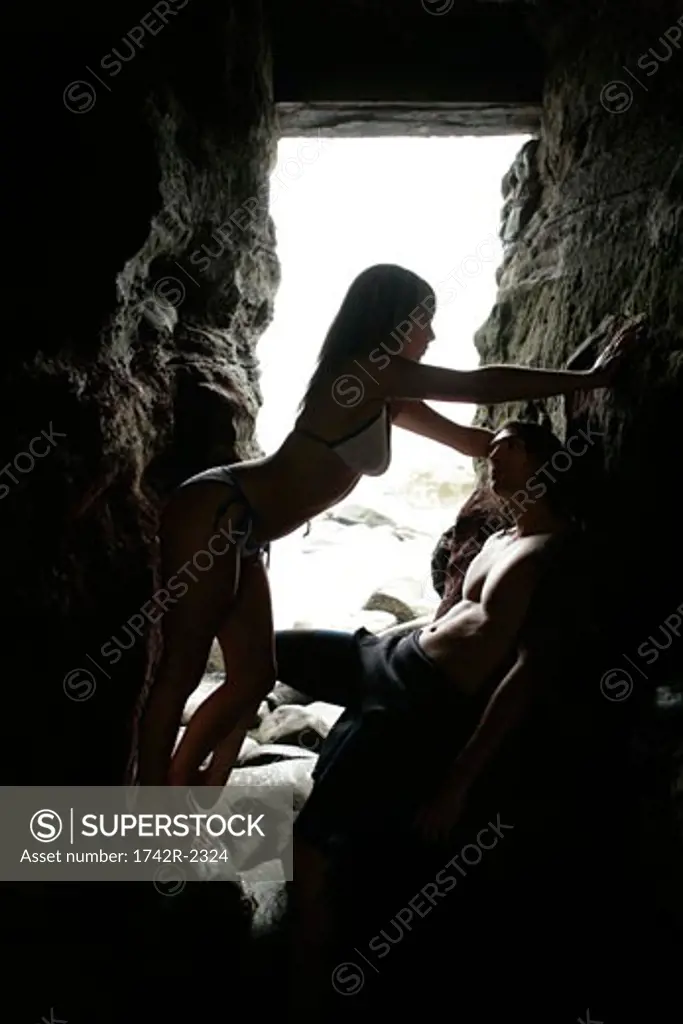 View of a couple standing inside a cave.