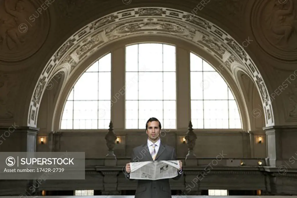 View of a businessman reading a newspaper.