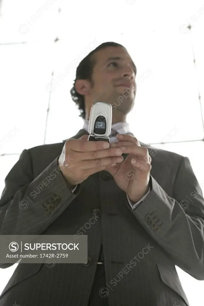 Portrait of a businessman holding a cellphone.