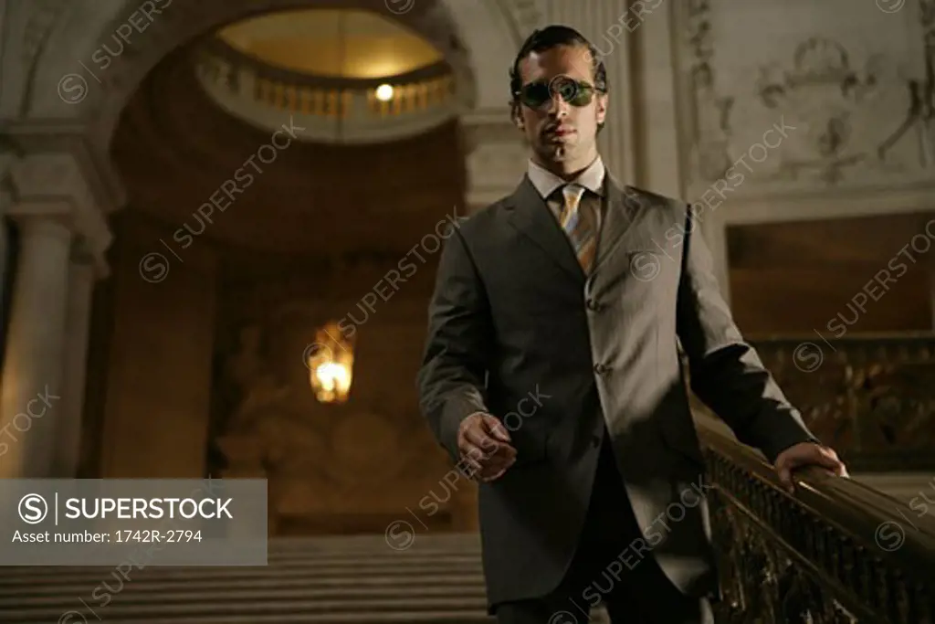 View of a businessman near a banister.