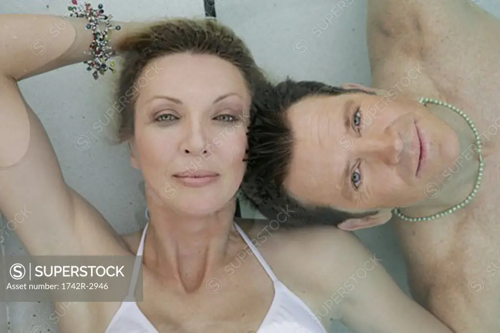 View of a couple underwater in a swimming pool.