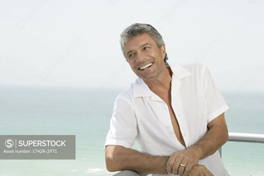 Mature married man smiling on a terrace