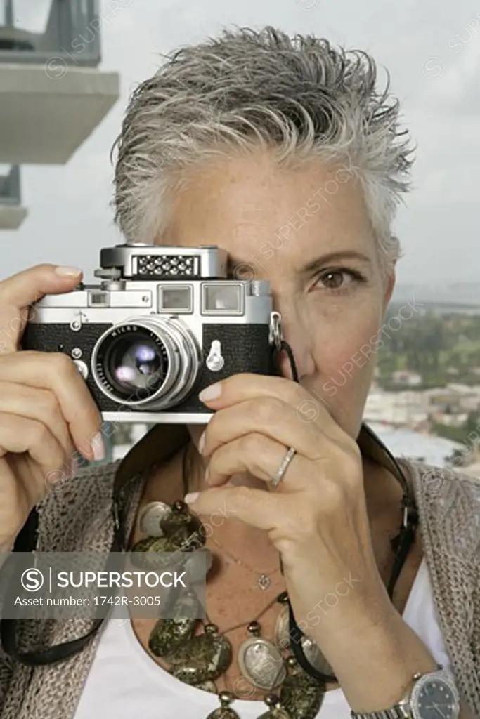 Mature woman taking a picture