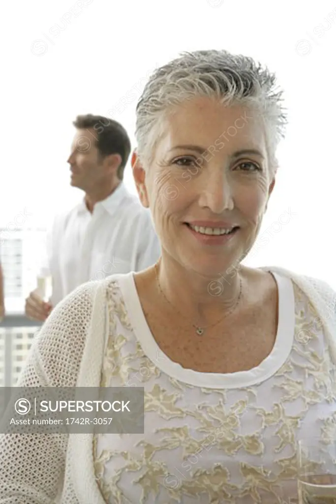 Mature woman with a short hair cut looking at camera