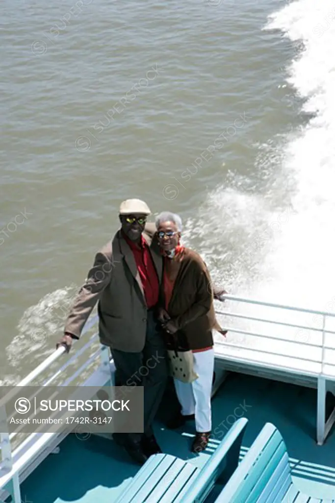 Mature couple standing on a boat
