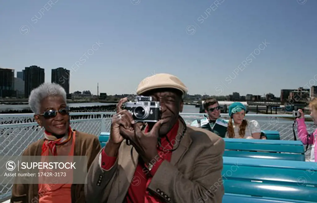 Passengers on board a boat taking pictures