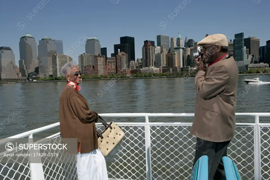 Mature man taking a picture of a woman