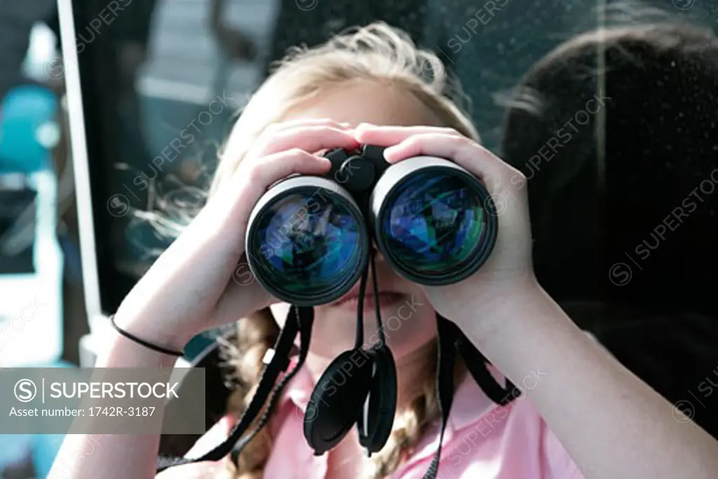 Little girl using binoculars