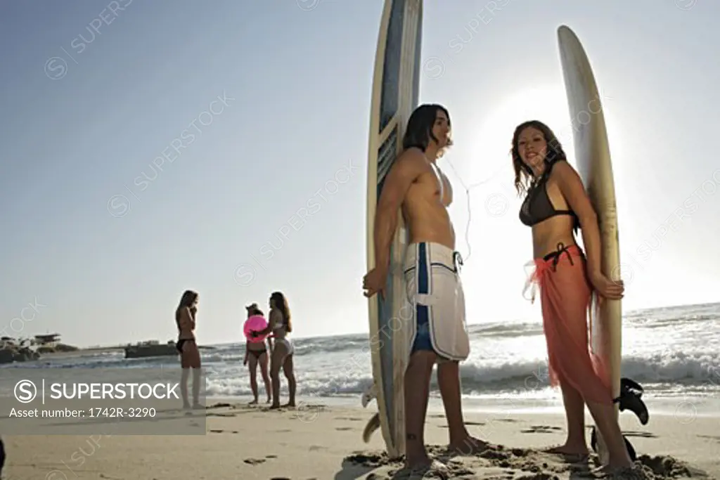 View of a couple with surfboards.