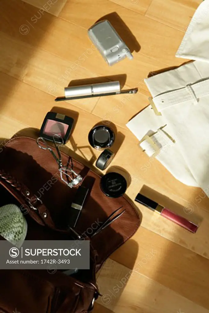 Handbag with makeup articles, elevated view