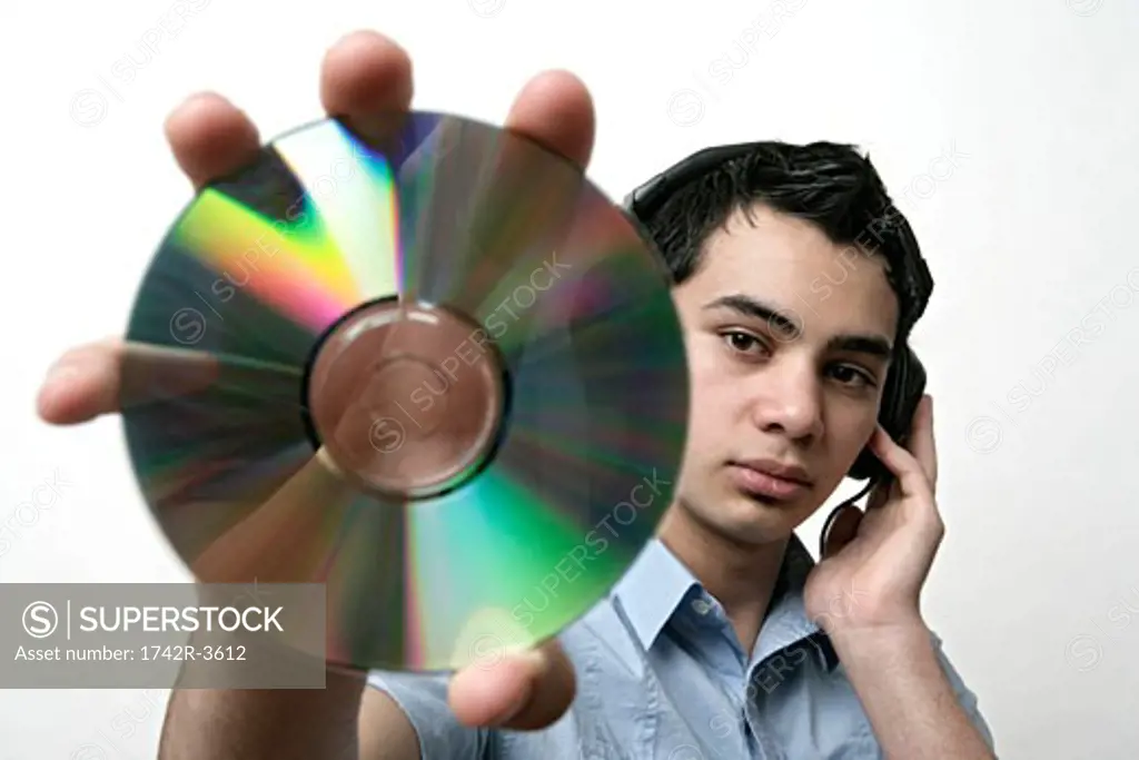 View of a teenage boy holding a CD.