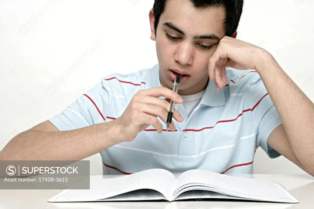 View of a teenage boy studying.