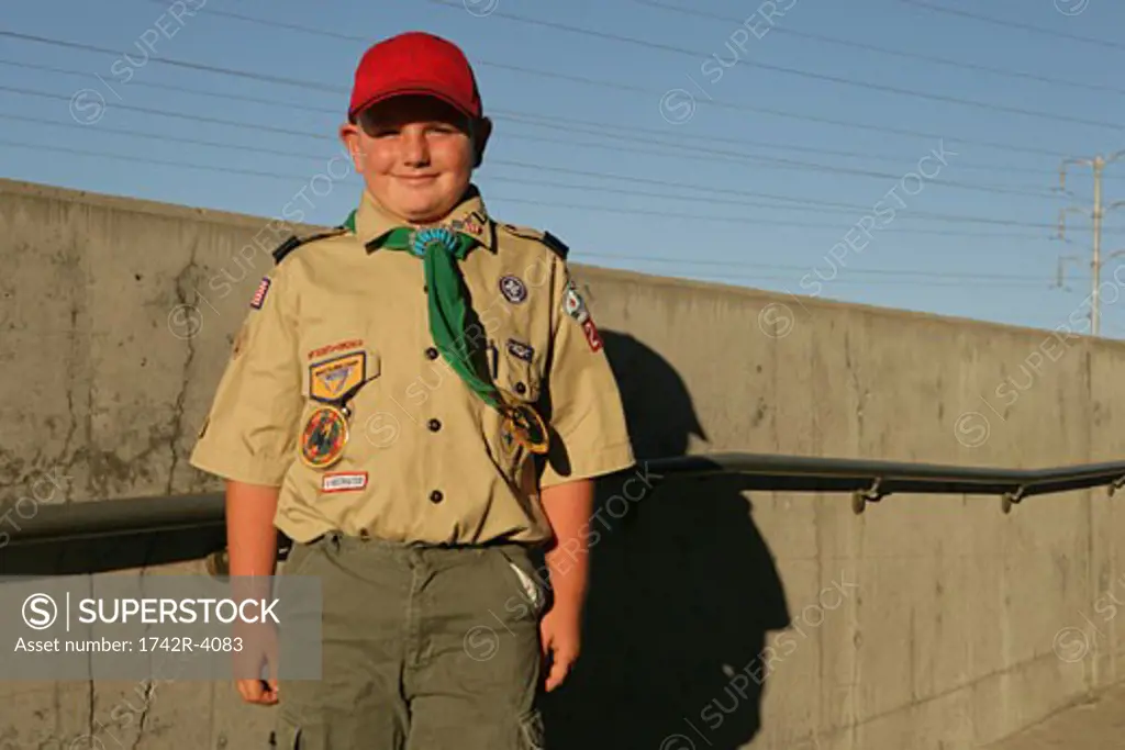 Boy scout standing outside