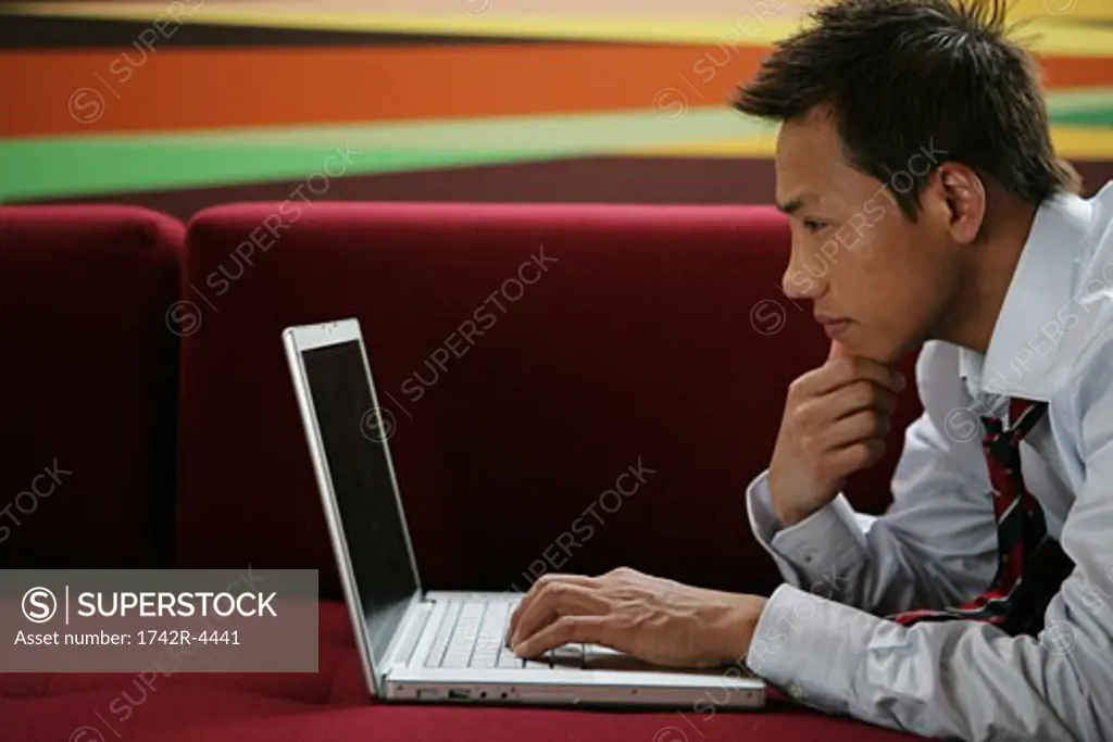 Young businessman looking at a laptop computer