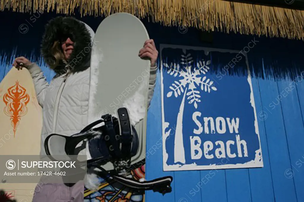Woman holding snowboards
