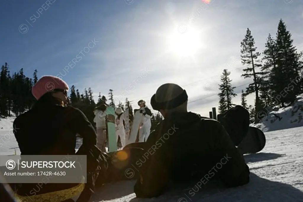 Couple sitting on a ski slope