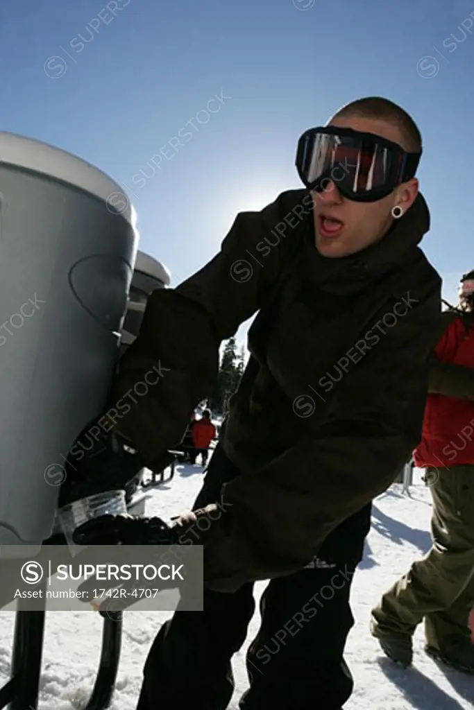 Man getting a drink from a cooler