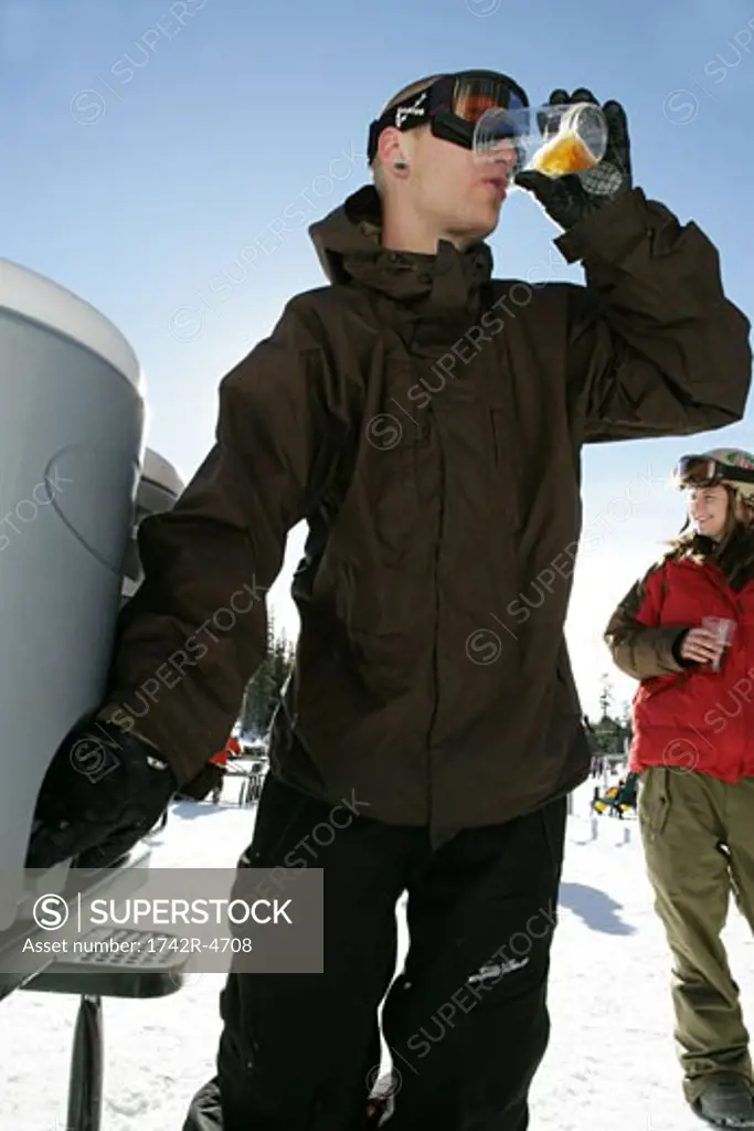 Man drinking on a ski slope
