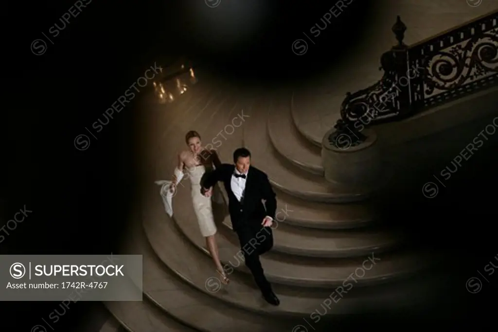 Couple walking down a staircase