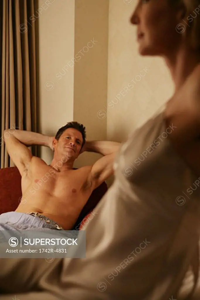 Shirtless mature man looking at a woman