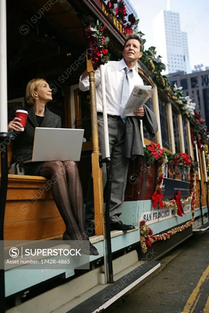 Two people on a trolley car