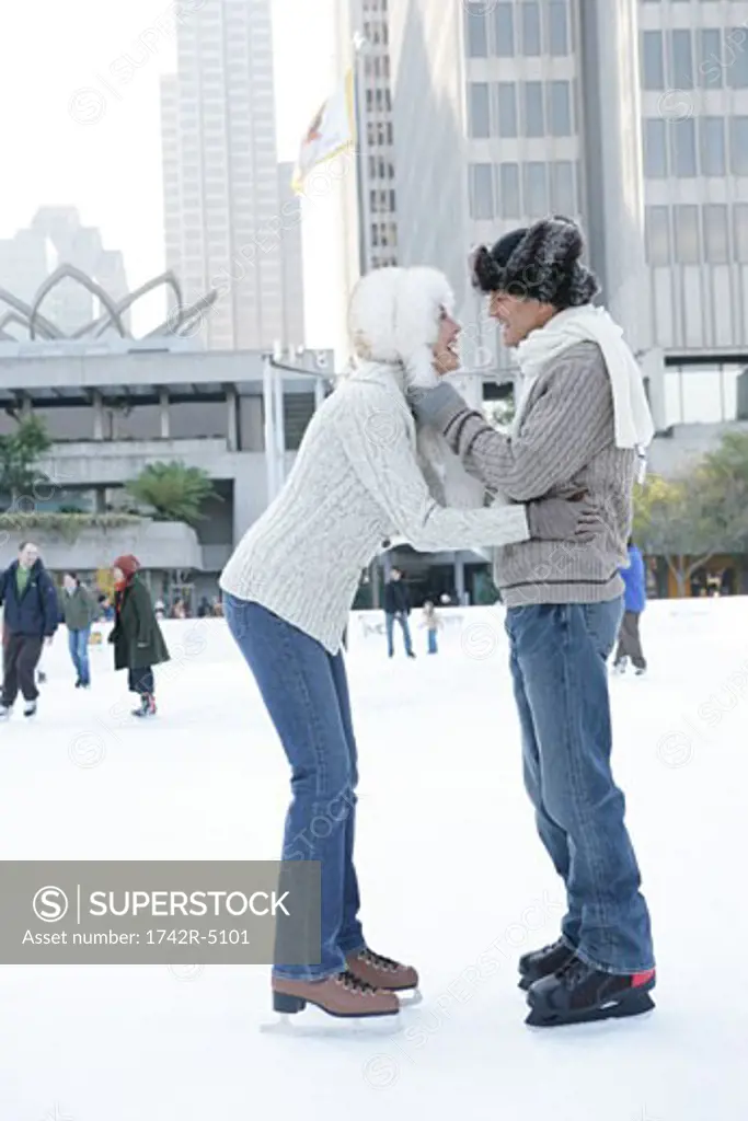 Mature couple ice skating