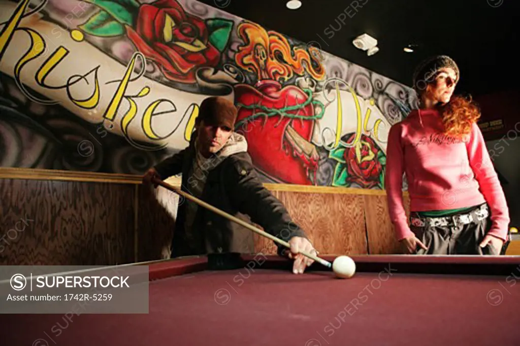 Man and woman playing pool