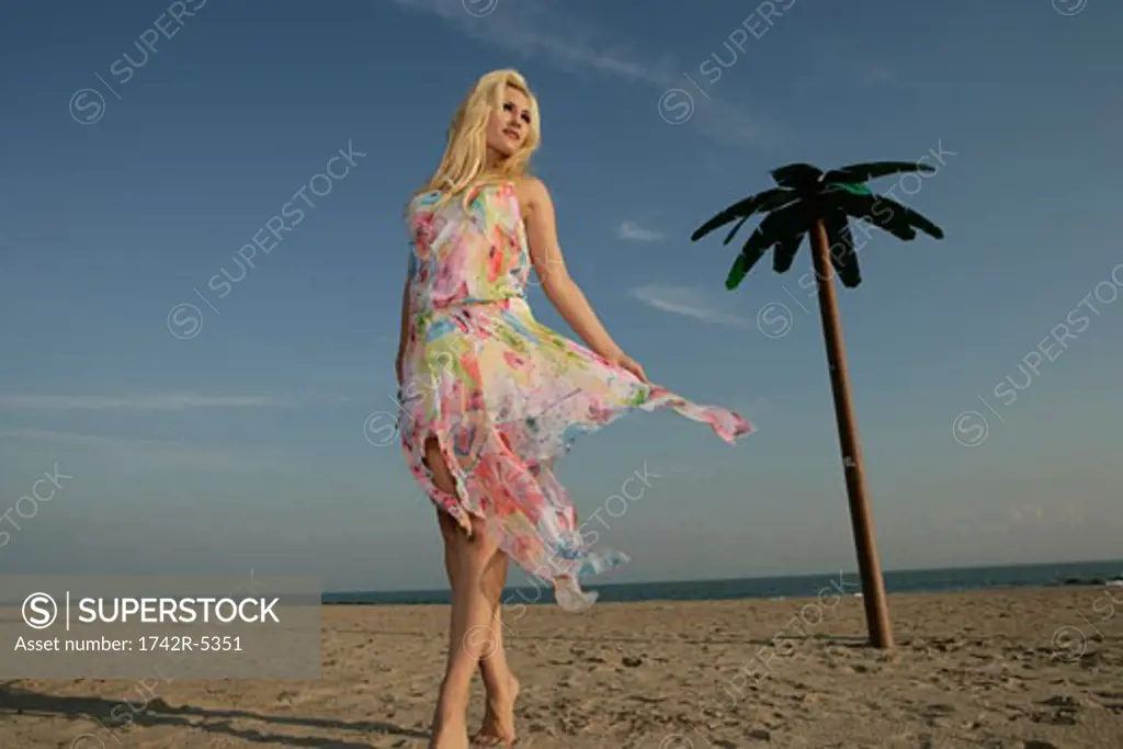 Blond woman posing in sand