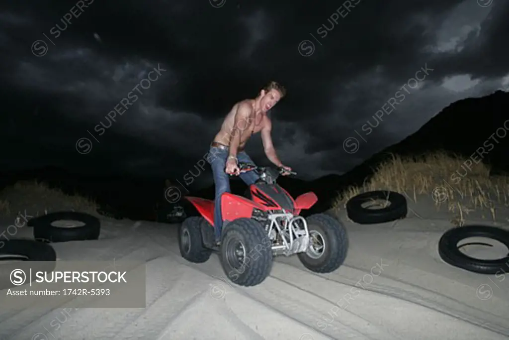 Young man riding an ATV