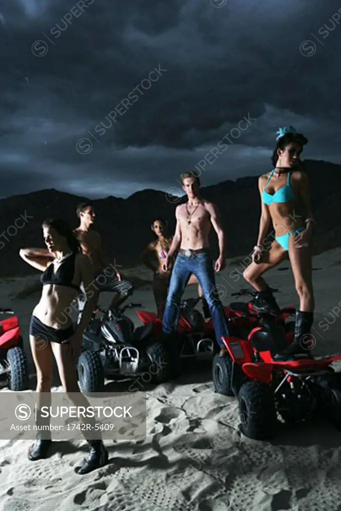 Group of people standing on ATVs