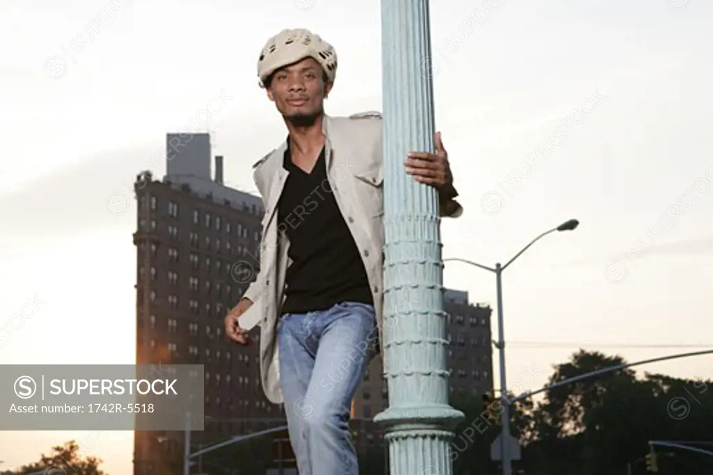 African American man holding a pole looking at camera