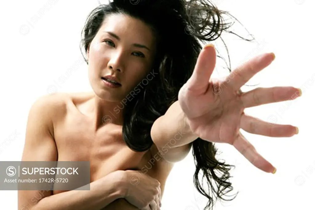 Asian woman reaching in cameras direction