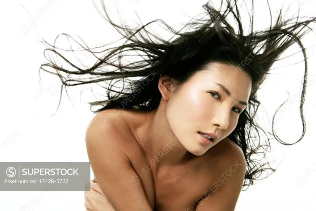 Wind blowing Asian woman's hair