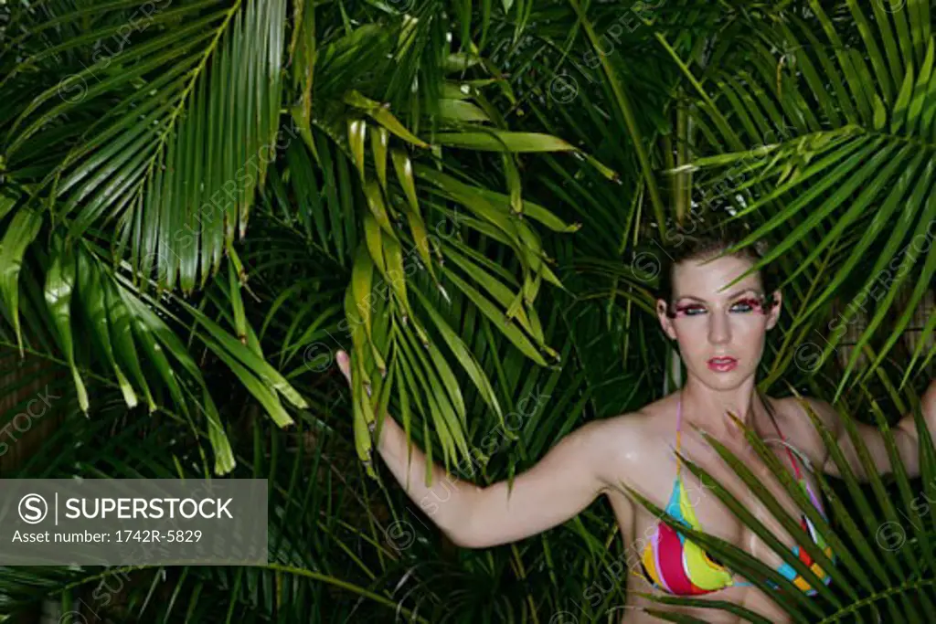 Woman standing in lush tropical trees